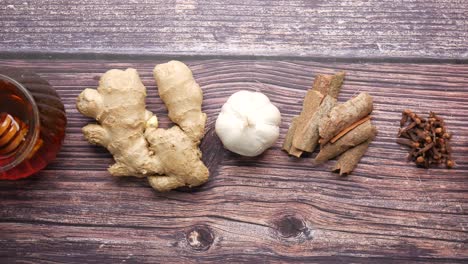 natural remedies with ginger, garlic, cinnamon, cloves, and orange