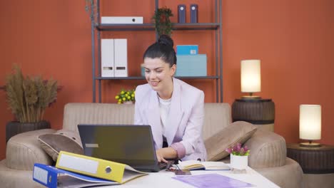 Home-office-worker-young-woman-looking-with-satisfied-expression.