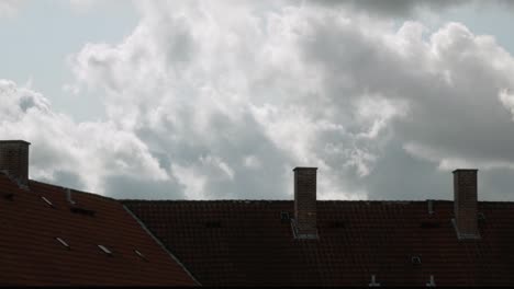 house roof under fast moving clouds. time lapse