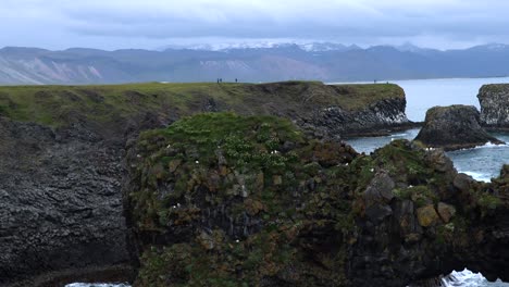 rock reaching out of water at arnarstapi on peninsula snæfellsnes in iceland, 4k