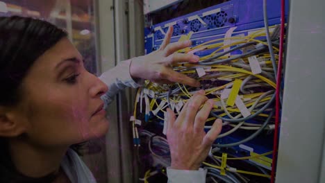 Animation-of-pink-lights-over-focused-biracial-women-connecting-wires-in-server