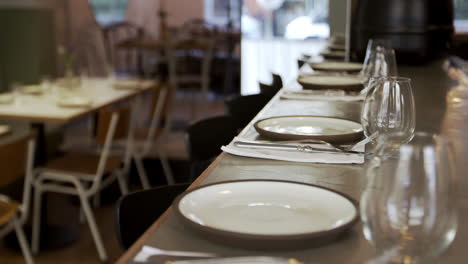 place settings at the bar of empty restaurant, tilt shot