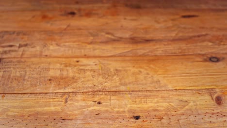 Close-up-of-carajillo-cocktail-being-placed-and-removed-from-a-wooden-table-in-a-restaurant