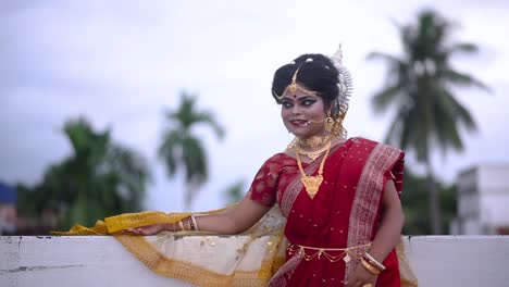 Happy-Indian-Bride-smiling-and-relaxing-outdoor-on-cloudy-evening