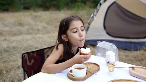 child enjoying a dessert during a camping trip