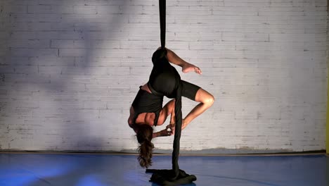 amazing performance of a flexible woman performing and training aerial dance routine, aerial dancer