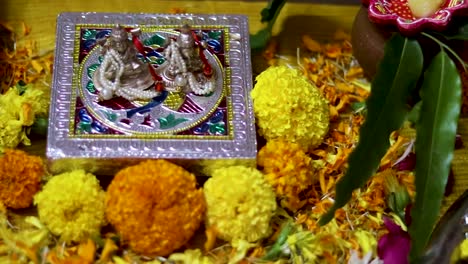 hindu god religious ritual festive pray with flowers from top angle