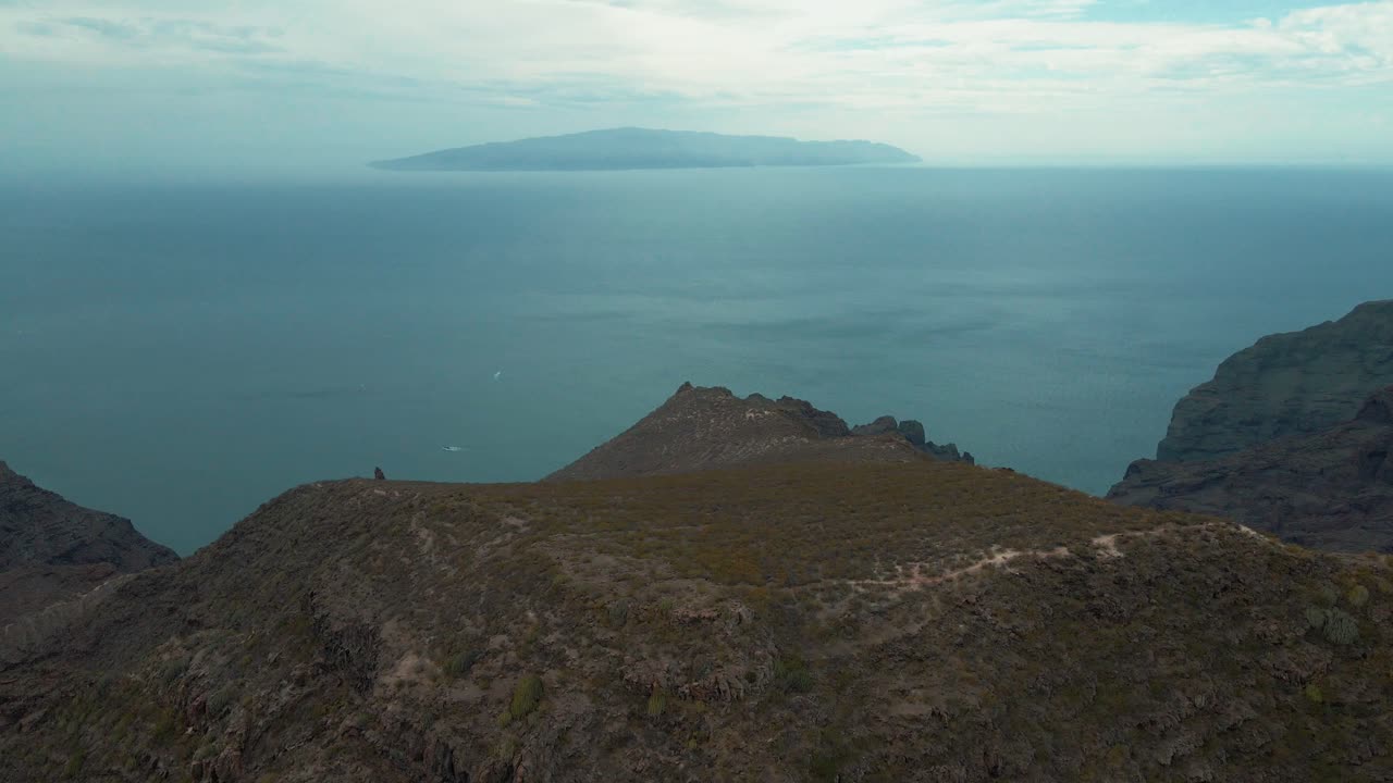 Beautiful Forwarding Aerial Shot of Picturesque Mountains Overlooking Ocean, Spain