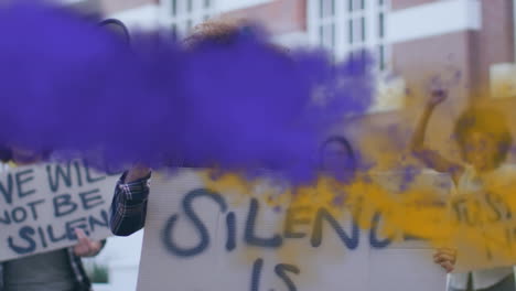 animation of purple and yellow smoke trails over biracial woman using megaphone at protest