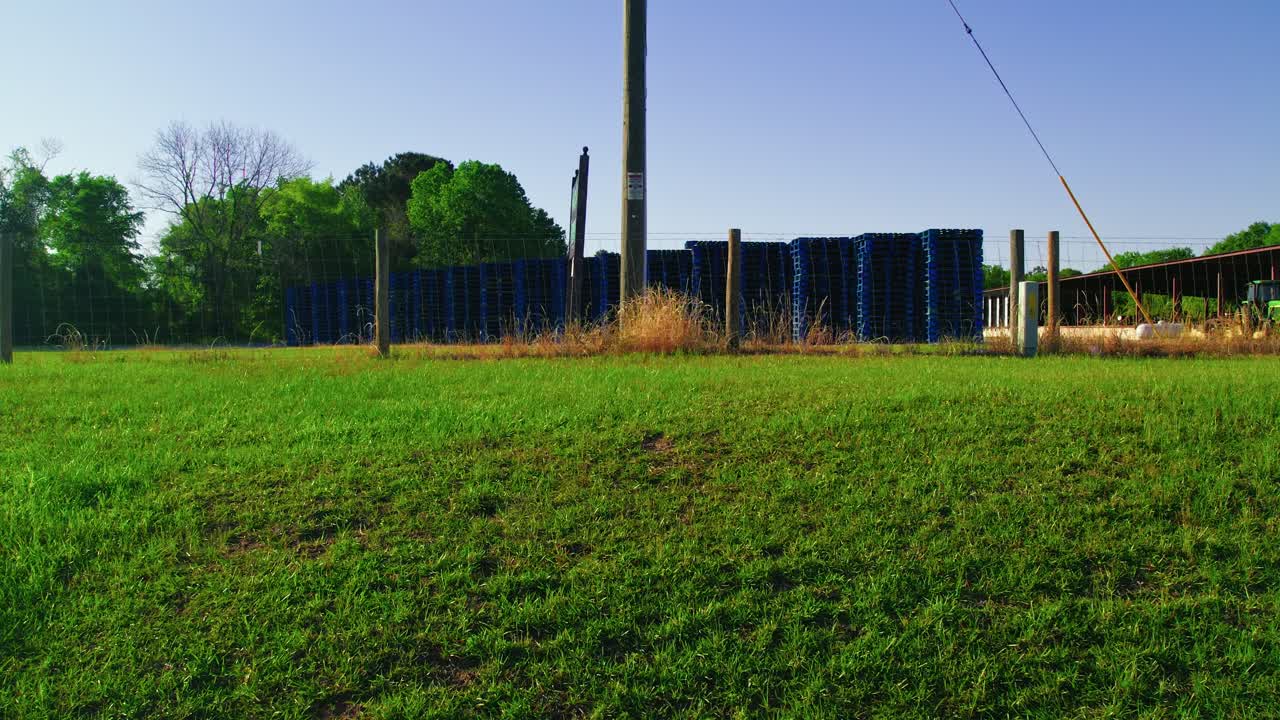 Rising Aerial Shot of Stacked Blue Pallets at Industrial Storage Yard. Georgia, USA