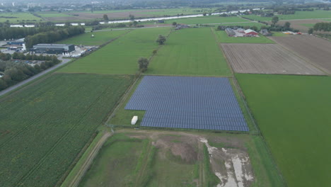 Jib-down-of-small-solar-panel-park-surrounded-by-green-fields