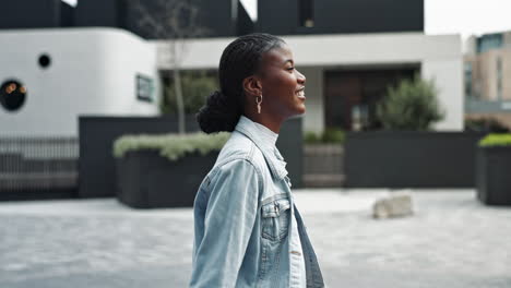 a young woman walking down a city street smiling