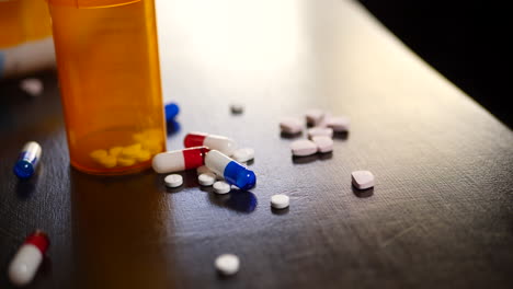 prescription drug pills, narcotic tablets, pain killers and pharmacy bottles on a table