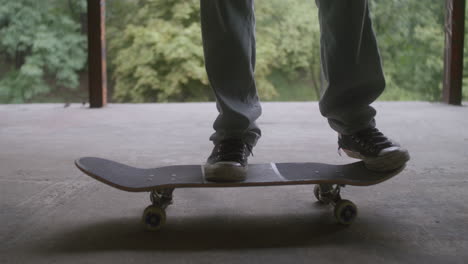 caucasian boy skateboarding in a ruined building.