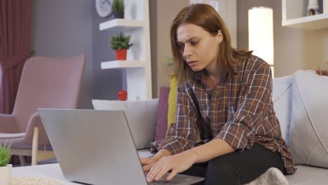 Messaging-on.-Young-girl-is-texting-on-laptop.