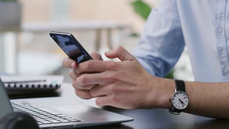 4k video footage of an unrecognisable businessman sitting alone in his office and using cellphone