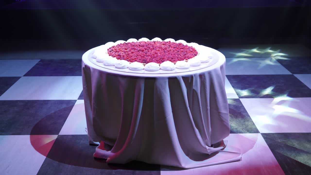 large berry dessert displayed on elegant table with stage lights