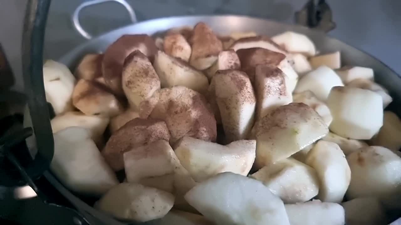 Delicious homemade cinnamon and apple stewed in large rustic pot on home kitchen stove
