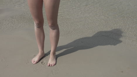 woman legs on the beach