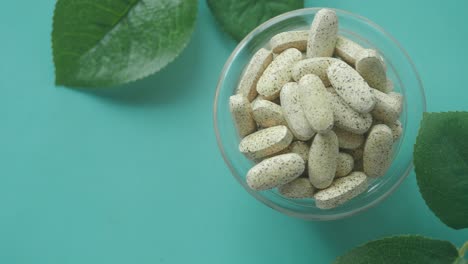 healthy vitamins in a bowl with green leaves