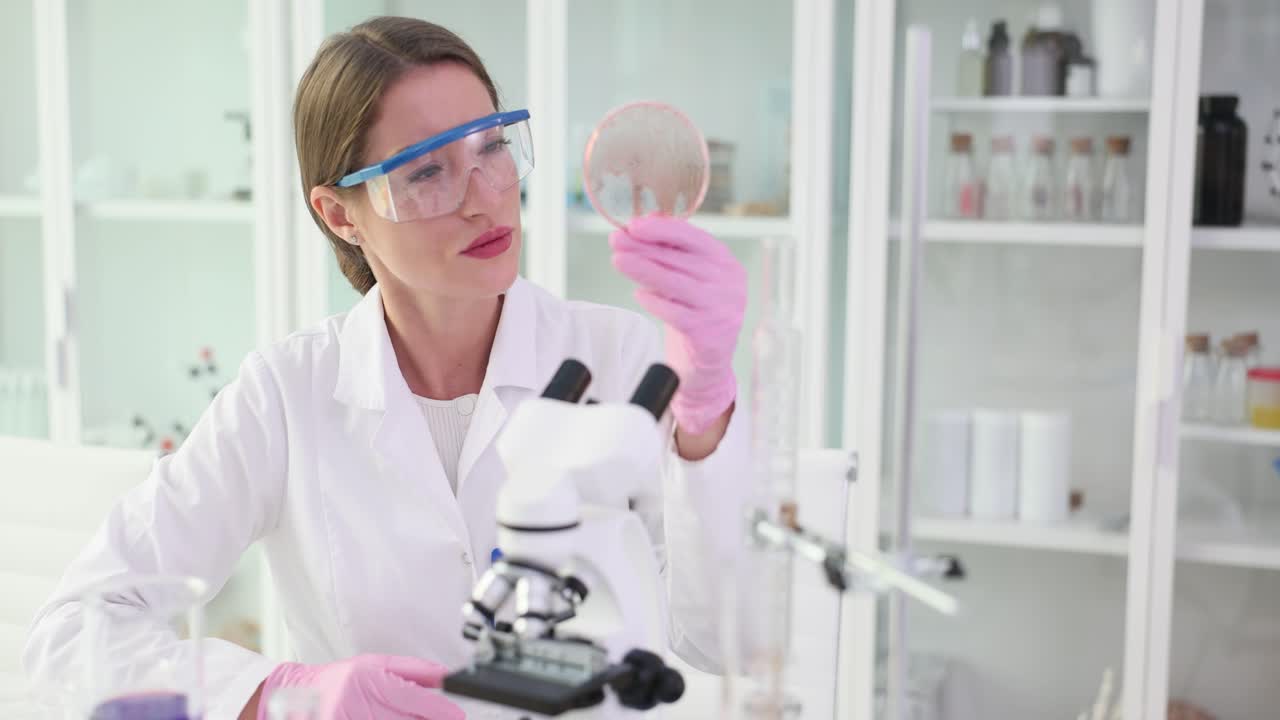 Scientist examining a petri dish in a laboratory