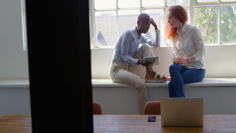side view of happy young mixed-race business team working on digital tablet in a modern office 4k