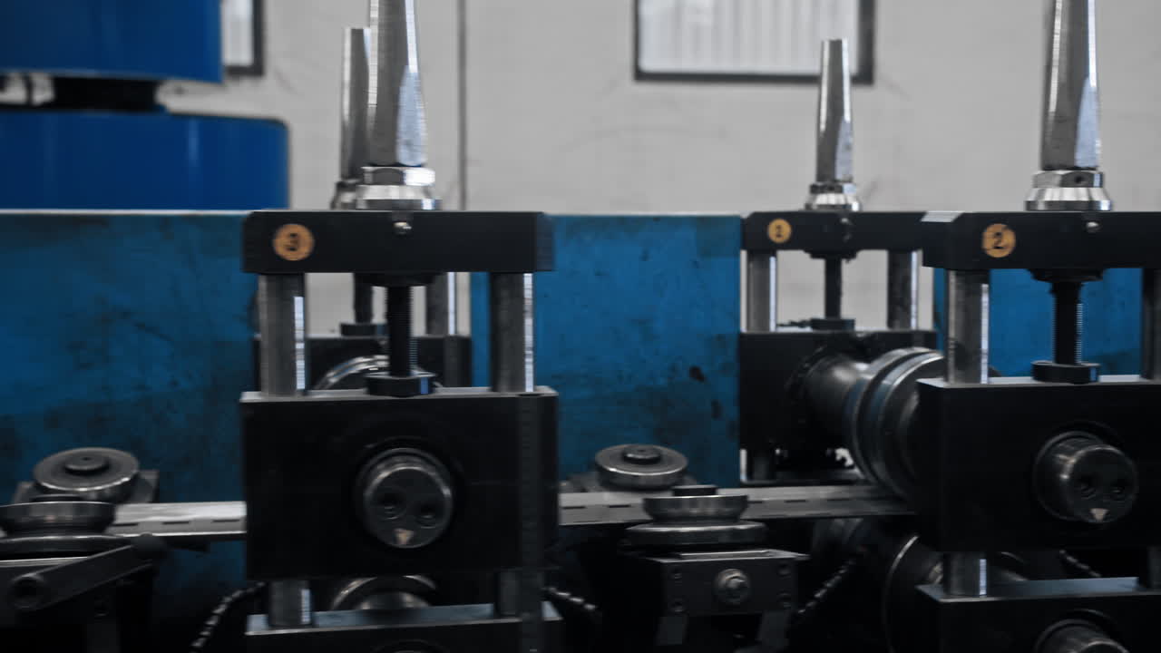 The factory's conveyor belt moves steel strip, essential for manufacturing high-tech products