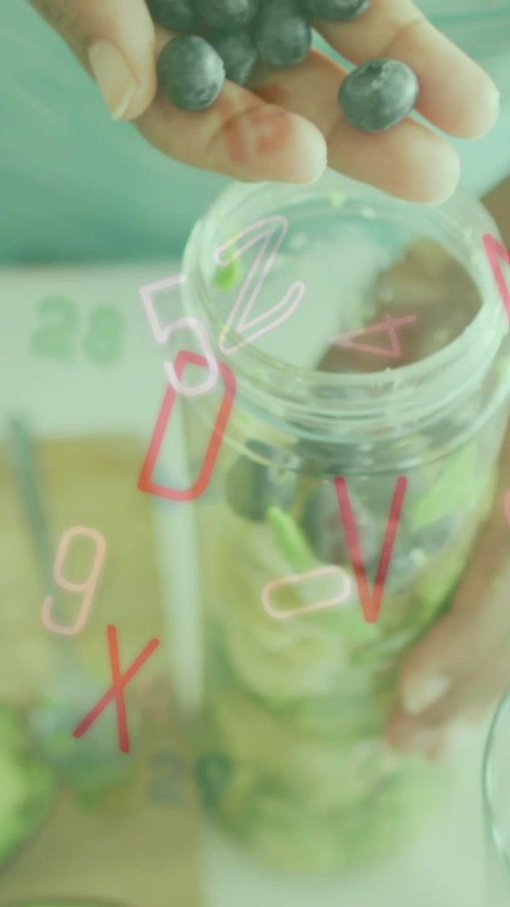 Animation of letters and numbers falling over caucasian woman preparing breakfast with berries