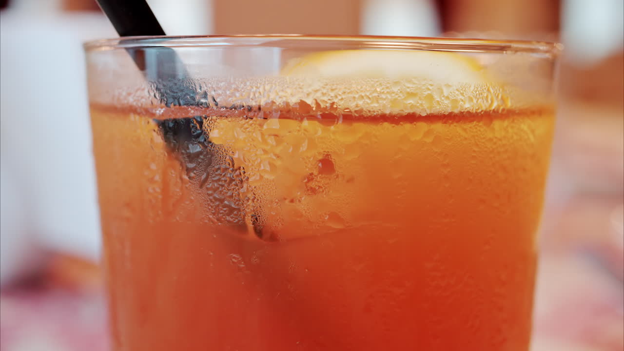 Close up of an orange cocktail on a table at a restaurant