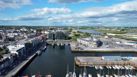 aerial drone shot of dock and boats in the long walk in galway bay, ireland