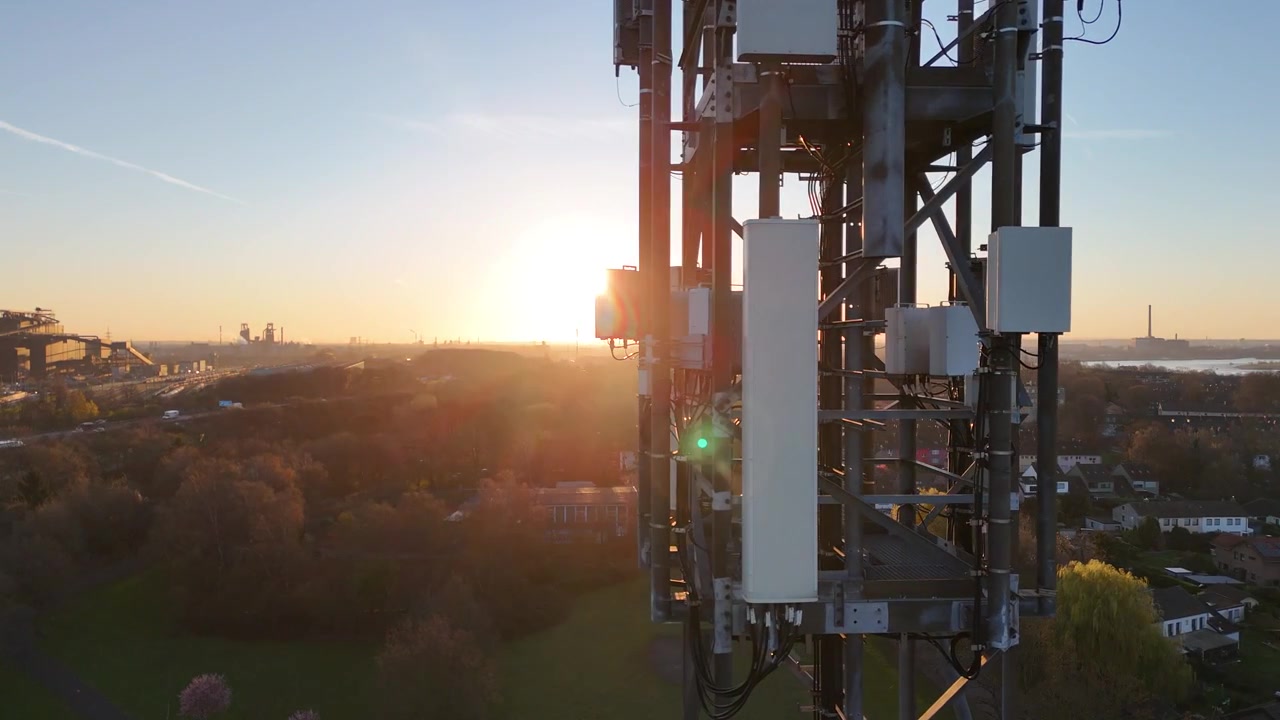 Drone flies left to right past the mast, ending with lens flare and a distant outlook from a close side perspective.