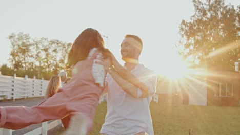 dad circling daughter in arms outside