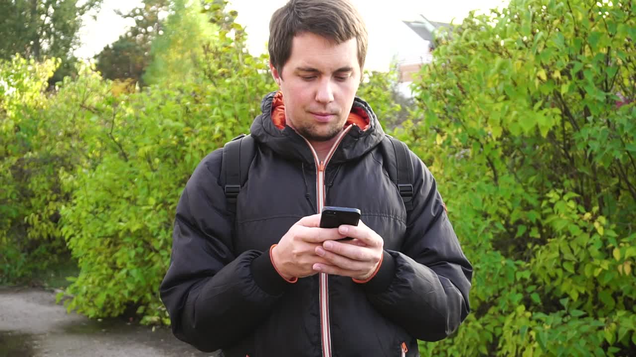 Man Texting on Phone Outdoors