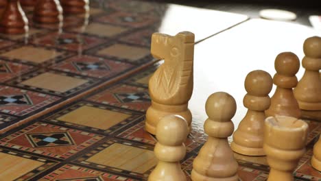 male finger moving horse figure during playing wooden chess game ,close up dolly