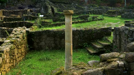 ancient stone ruins and a single standing column