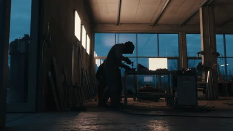 Worker welding metal in a workshop