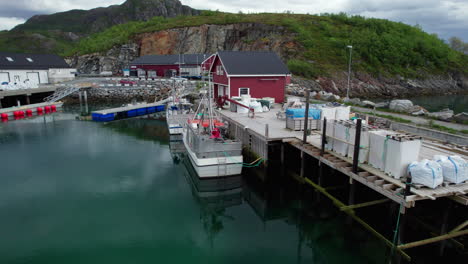 Aerial-forwarding-close-up-shot-of-Fishing-vessel-in-Tonnes-Harbor,-Helgeland,-Northern-Norway