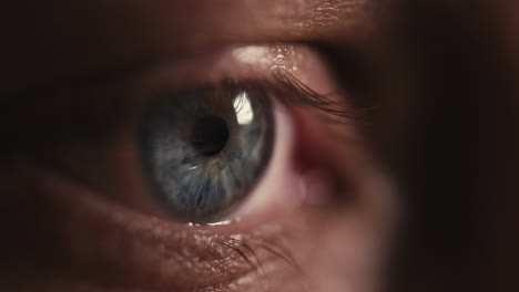 macro-close-up-shot-of-a-blue-human-eye-looking-around-and-blinking