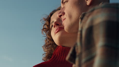 romantic couple standing on beach. happy woman and man posing at camera