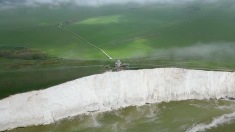 flying around belle tout lighthouse, white cliffs, foggy sky and sea