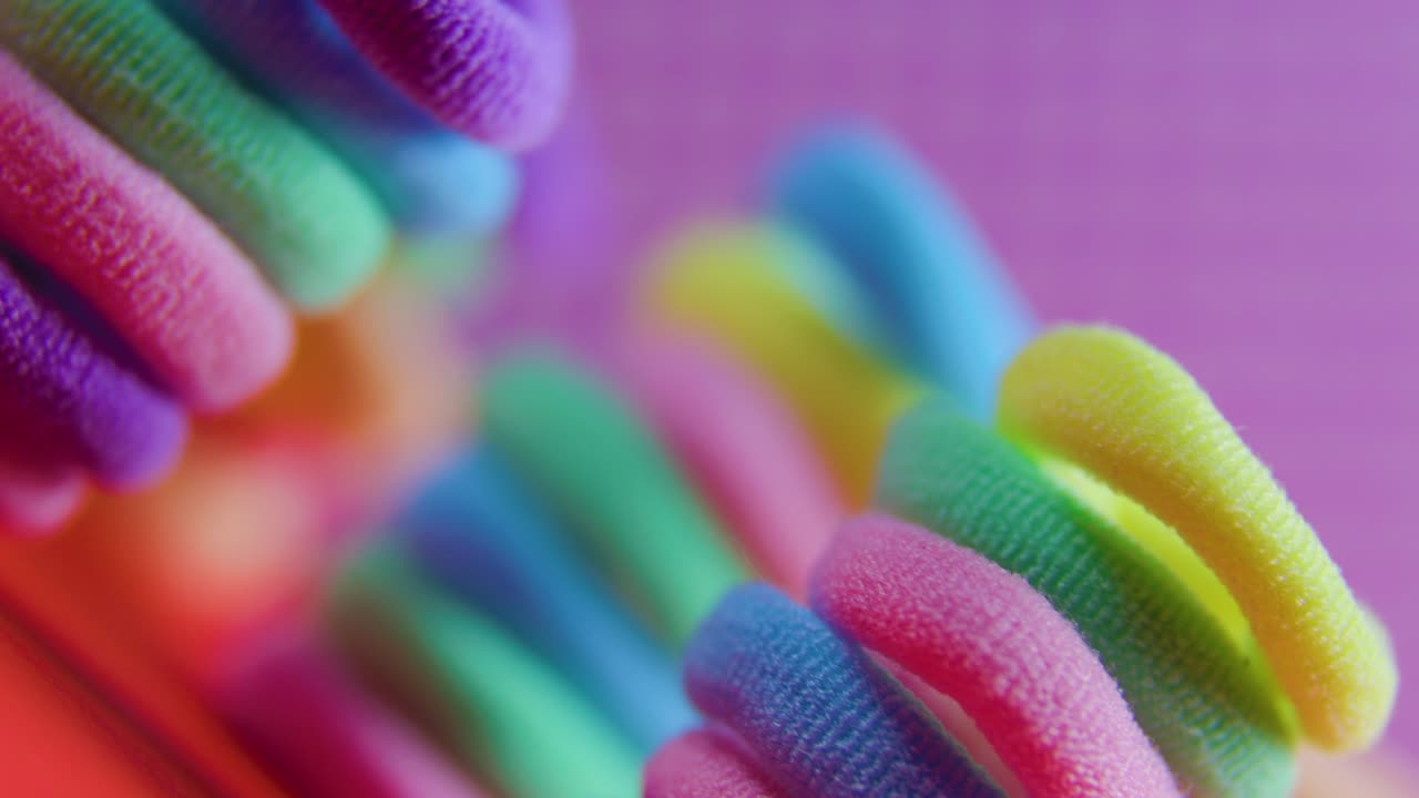 las bandas de goma se cierran girando vívidamente sobre el fondo violeta.