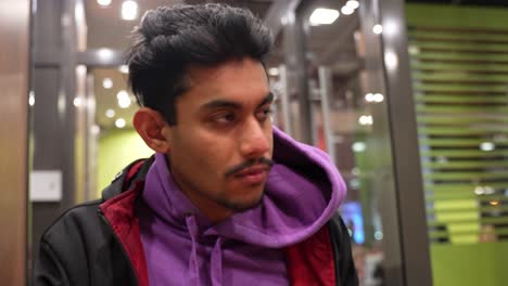 Close-up-portrait-of-Sri-Lankan-man-eating-fast-food-fries-wear-casual-clothing