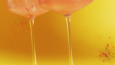 Animation-of-confetti-falling-and-cocktail-on-yellow-background