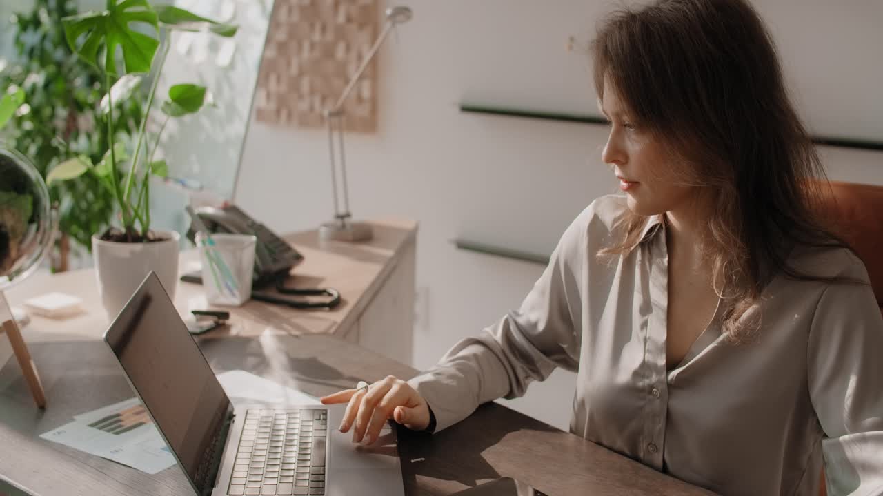 Woman Working on Laptop in Modern Office