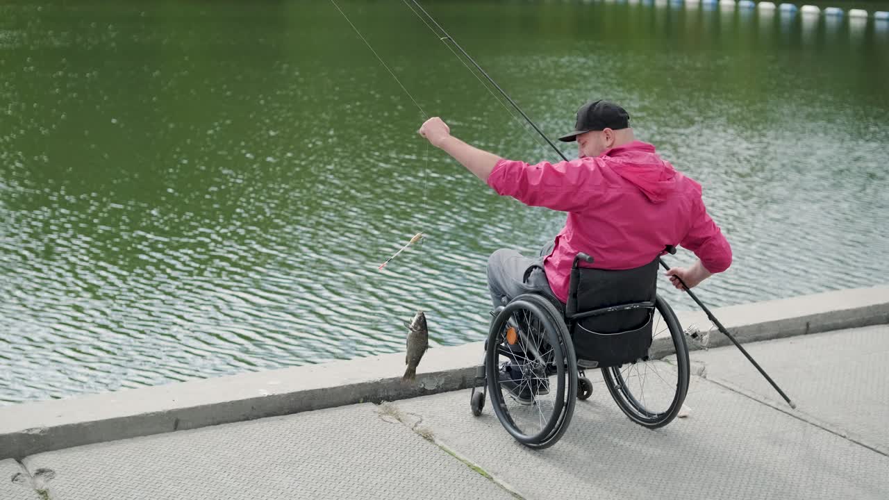 persona con discapacidad física que utiliza silla de ruedas para pescar en el muelle de pesca