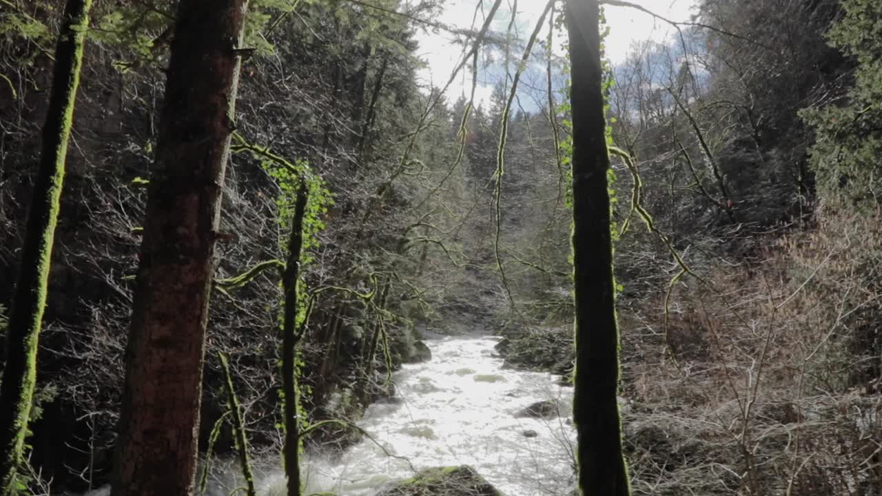 video of water waves from an overflowing river in Creux Du Van, Neuchatel, Switzerland. Water flowing from the dam channel. view of the river channel