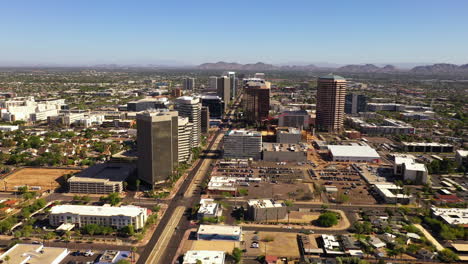 Aerial-rising-and-flying-towards-highrises-Phoenix,-Arizona