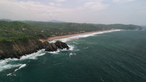 aerial wide drone shot of zipolite beach oaxaca