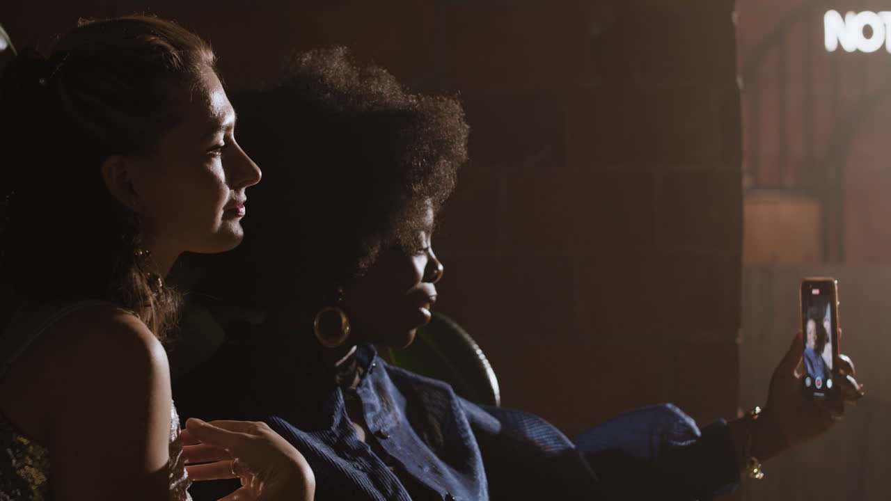 Two women taking a selfie at a bar