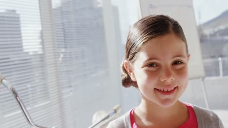 girl as female executive smiling at camera in office 4k